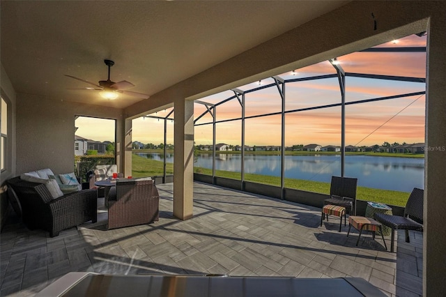 19183 Coastal Shore Ter, Land O Lakes, FL 34638 - view of patio / terrace featuring a water view, a lanai, a ceiling fan, and an outdoor living space