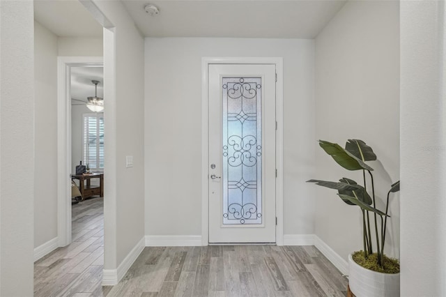 19183 Coastal Shore Ter, Land O Lakes, FL 34638 - entryway with light wood-type flooring, baseboards, and a ceiling fan
