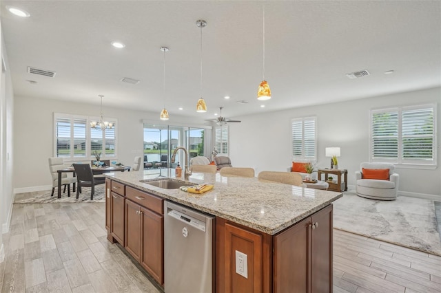 19183 Coastal Shore Ter, Land O Lakes, FL 34638 - kitchen with stainless steel dishwasher, a sink, open floor plan, light wood-type flooring, and baseboards