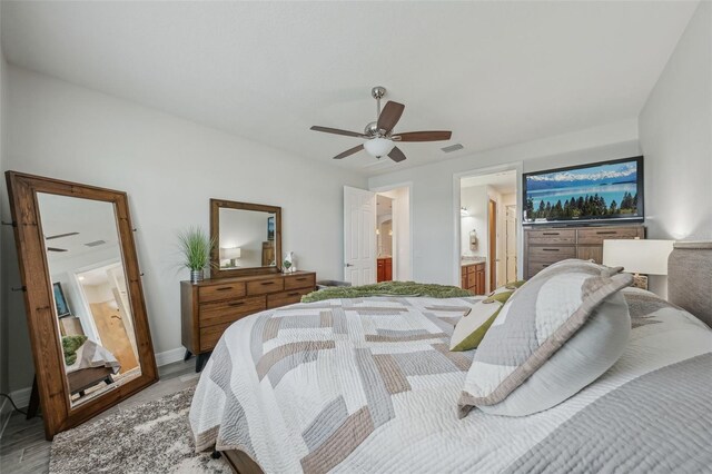 19183 Coastal Shore Ter, Land O Lakes, FL 34638 - bedroom featuring light wood-type flooring, ensuite bathroom, ceiling fan, and baseboards