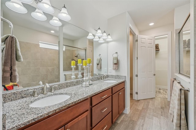 19183 Coastal Shore Ter, Land O Lakes, FL 34638 - full bathroom with a stall shower, double vanity, wood finished floors, recessed lighting, and a closet
