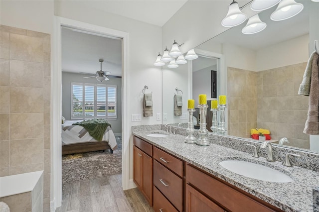 19183 Coastal Shore Ter, Land O Lakes, FL 34638 - ensuite bathroom with wood finished floors, double vanity, and ceiling fan