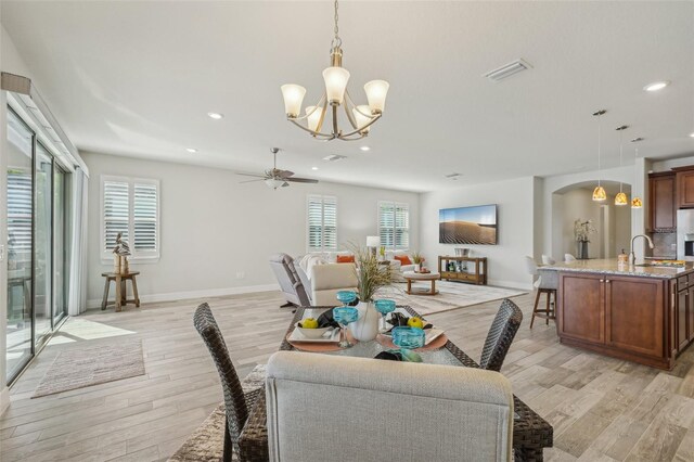 19183 Coastal Shore Ter, Land O Lakes, FL 34638 - dining area with a chandelier, light wood-type flooring, recessed lighting, a ceiling fan, and baseboards