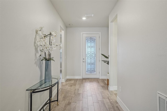 19183 Coastal Shore Ter, Land O Lakes, FL 34638 - foyer entrance featuring light wood finished floors and baseboards