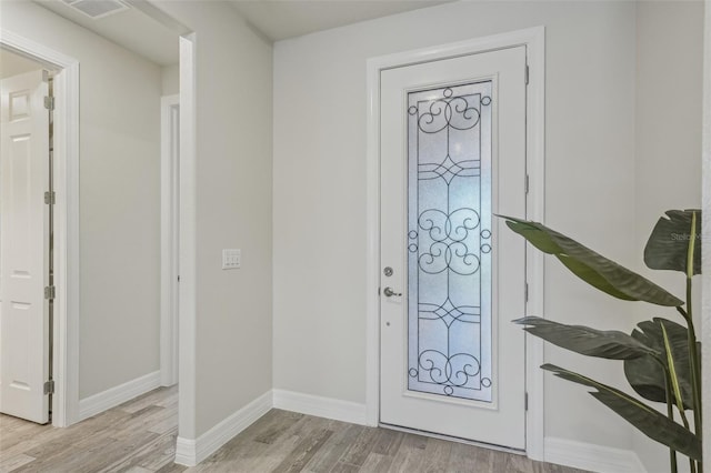 19183 Coastal Shore Ter, Land O Lakes, FL 34638 - foyer entrance featuring light wood finished floors and baseboards