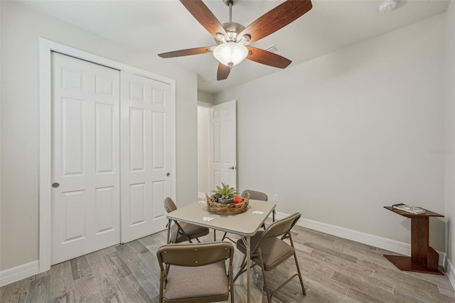 19183 Coastal Shore Ter, Land O Lakes, FL 34638 - dining area with ceiling fan, baseboards, and light wood-style floors