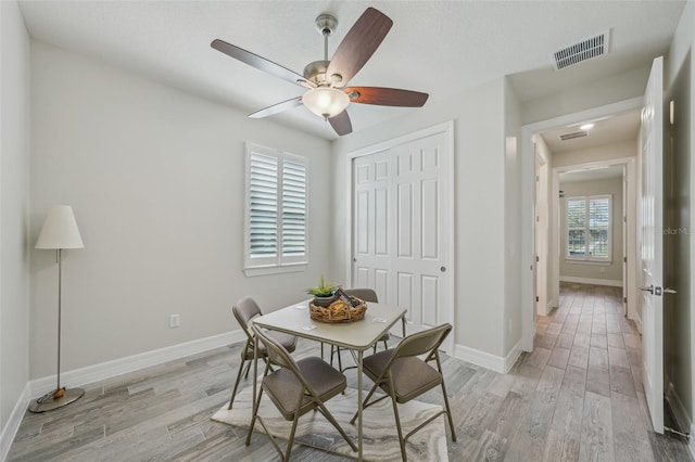 19183 Coastal Shore Ter, Land O Lakes, FL 34638 - dining space with light wood-type flooring, ceiling fan, and baseboards