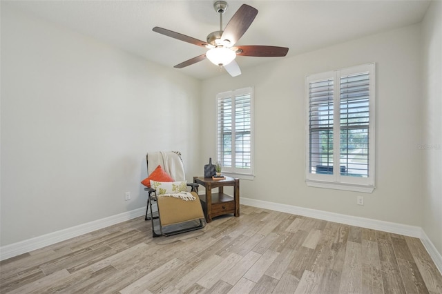 19183 Coastal Shore Ter, Land O Lakes, FL 34638 - living area featuring wood finished floors, a ceiling fan, and baseboards