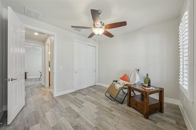 19183 Coastal Shore Ter, Land O Lakes, FL 34638 - living area with ceiling fan, light wood-style floors, and baseboards