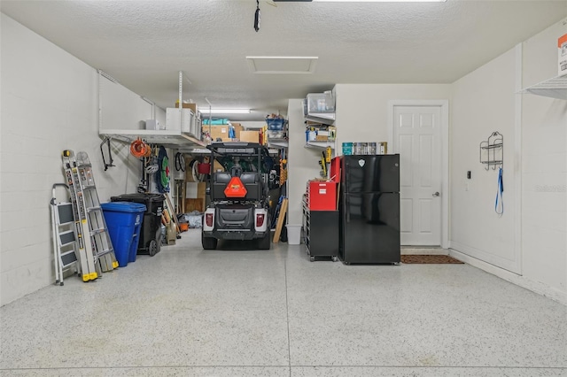 19183 Coastal Shore Ter, Land O Lakes, FL 34638 - garage featuring freestanding refrigerator