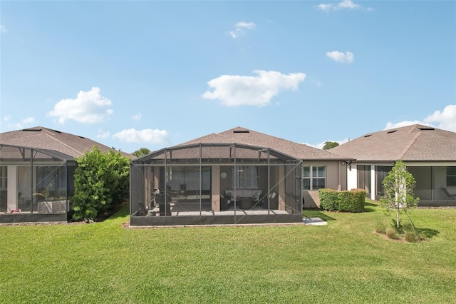 19183 Coastal Shore Ter, Land O Lakes, FL 34638 - back of property with a lawn and glass enclosure
