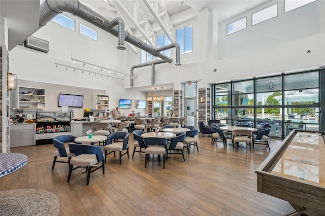 19183 Coastal Shore Ter, Land O Lakes, FL 34638 - dining room featuring a high ceiling, wood-type flooring, plenty of natural light, and a chandelier