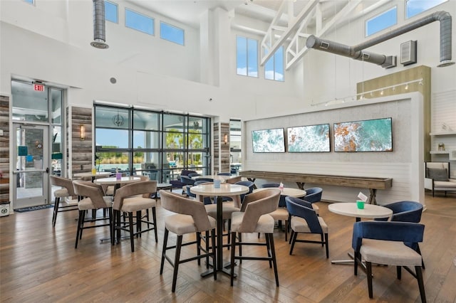 19183 Coastal Shore Ter, Land O Lakes, FL 34638 - dining room featuring a towering ceiling and hardwood / wood-style floors