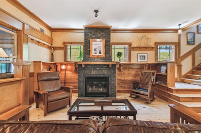 3112 W Wallcraft Ave, Tampa, FL 33611 - living room featuring hardwood / wood-style flooring, healthy amount of natural light, a brick fireplace, stairway, and wainscoting