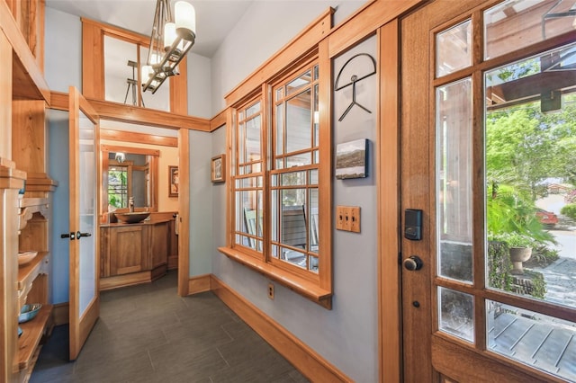 3112 W Wallcraft Ave, Tampa, FL 33611 - doorway featuring plenty of natural light, baseboards, and a chandelier