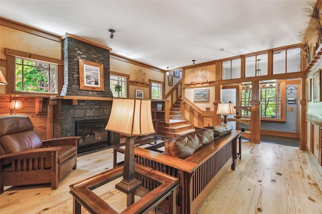 3112 W Wallcraft Ave, Tampa, FL 33611 - living room with light wood-type flooring, a fireplace, healthy amount of natural light, stairway, and crown molding