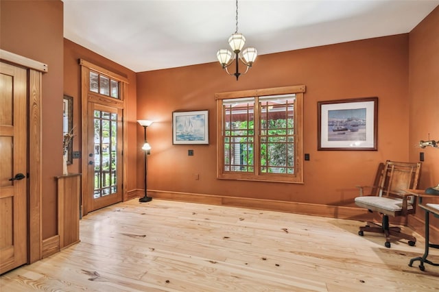 3112 W Wallcraft Ave, Tampa, FL 33611 - entryway with wood finished floors, a chandelier, healthy amount of natural light, and baseboards