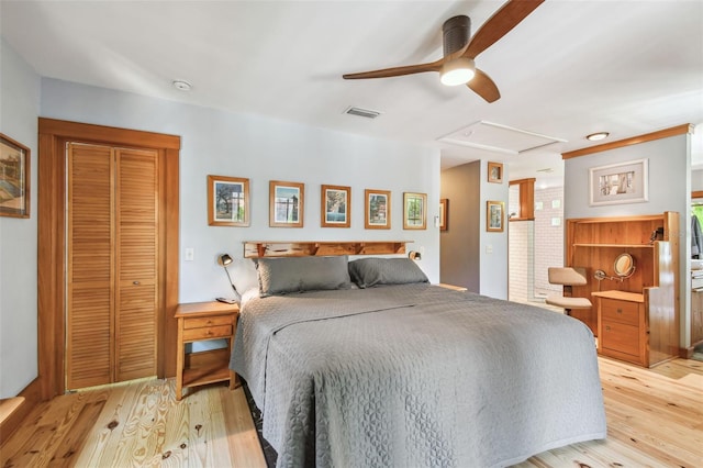 3112 W Wallcraft Ave, Tampa, FL 33611 - bedroom with light wood finished floors, ceiling fan, and a closet