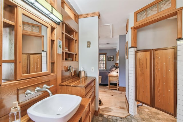 3112 W Wallcraft Ave, Tampa, FL 33611 - ensuite bathroom with a sink, built in features, and stone finish floors