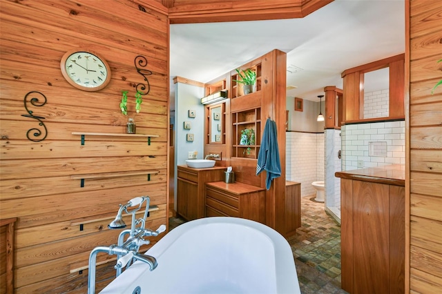 3112 W Wallcraft Ave, Tampa, FL 33611 - bathroom featuring a freestanding tub, toilet, wooden walls, and vanity