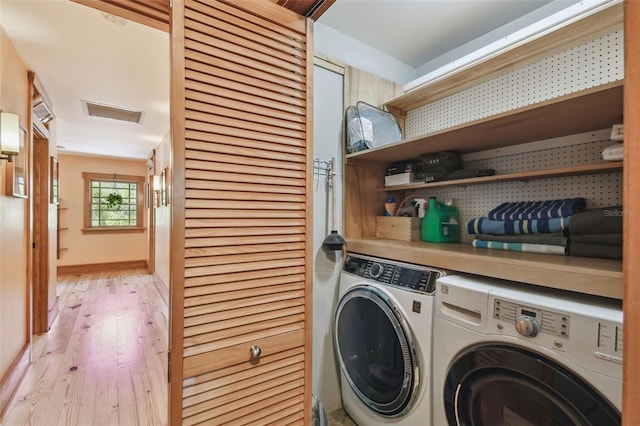 3112 W Wallcraft Ave, Tampa, FL 33611 - laundry area featuring independent washer and dryer and light wood-style flooring