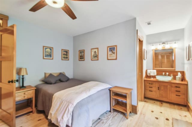 3112 W Wallcraft Ave, Tampa, FL 33611 - bedroom with a sink, light wood-type flooring, and ceiling fan