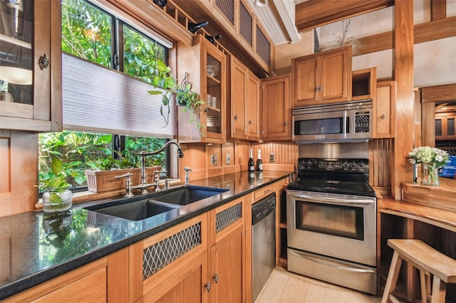 3112 W Wallcraft Ave, Tampa, FL 33611 - kitchen featuring stainless steel appliances, a sink, glass insert cabinets, and dark stone counters