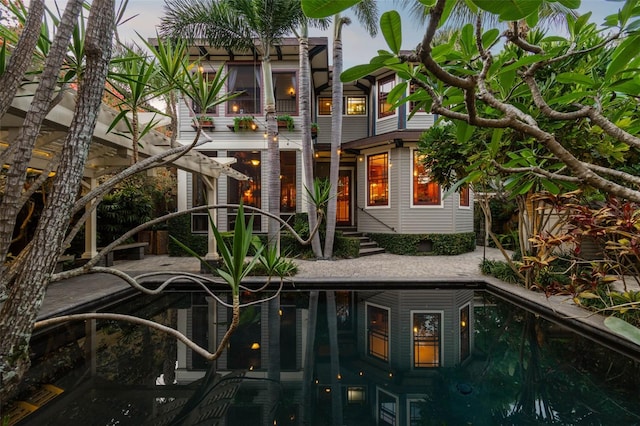 3112 W Wallcraft Ave, Tampa, FL 33611 - rear view of house featuring an outdoor pool, a balcony, and a patio area