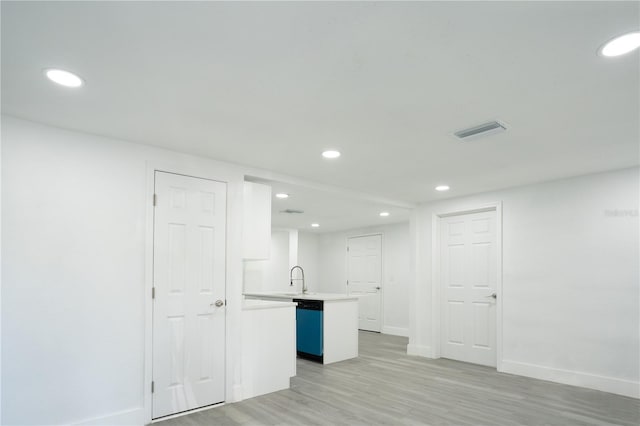 5510 12th St, Zephyrhills, FL 33542 - basement with recessed lighting, light wood-type flooring, baseboards, and a sink