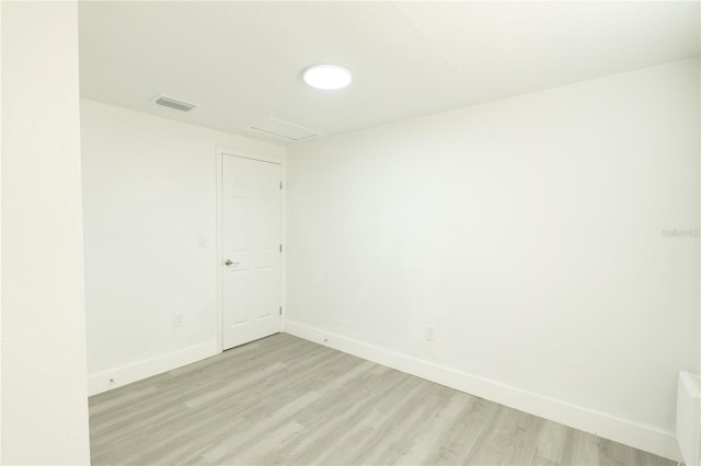 5510 12th St, Zephyrhills, FL 33542 - empty room with light wood-style floors, baseboards, and attic access