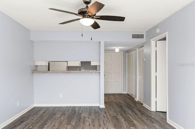 6324 Newtown Cir Unit 24B1, Tampa, FL 33615 - kitchen with freestanding refrigerator, wood finished floors, a ceiling fan, baseboards, and a textured ceiling