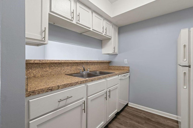 6324 Newtown Cir Unit 24B1, Tampa, FL 33615 - kitchen featuring white dishwasher, a sink, dark wood-type flooring, refrigerator, and baseboards