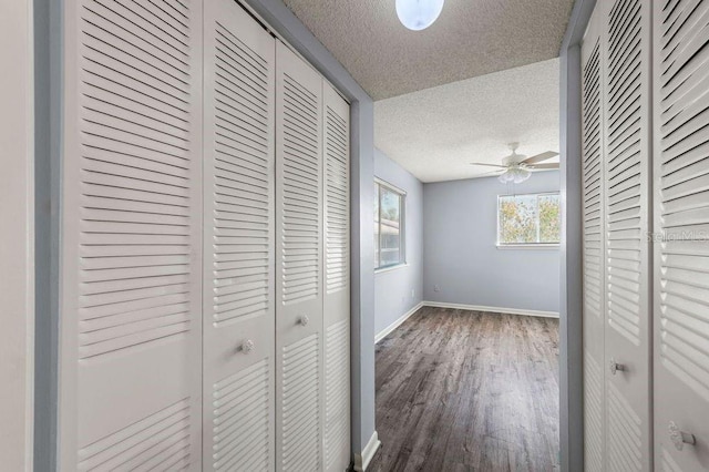6324 Newtown Cir Unit 24B1, Tampa, FL 33615 - hall with a textured ceiling, baseboards, and wood finished floors