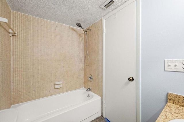 6324 Newtown Cir Unit 24B1, Tampa, FL 33615 - full bath featuring bathing tub / shower combination and a textured ceiling