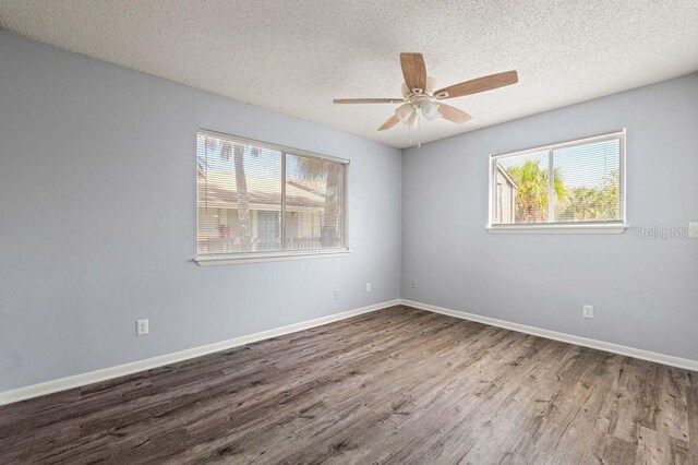 6324 Newtown Cir Unit 24B1, Tampa, FL 33615 - spare room with healthy amount of natural light, wood finished floors, a ceiling fan, a textured ceiling, and baseboards