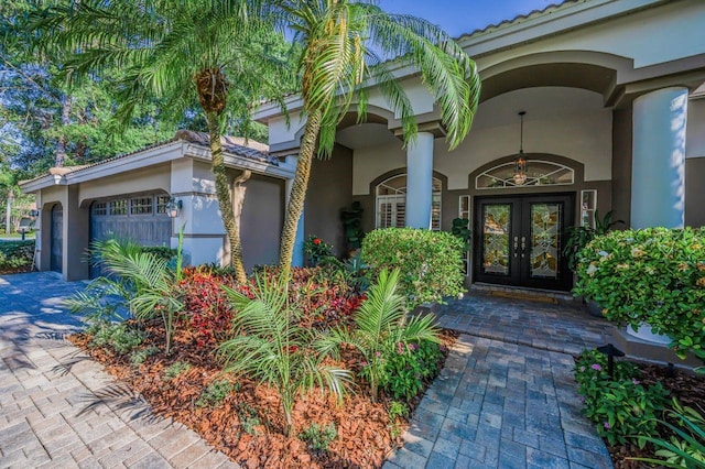 4962 Turtle Creek Trl, Oldsmar, FL 34677 - property entrance featuring french doors, stucco siding, and an attached garage