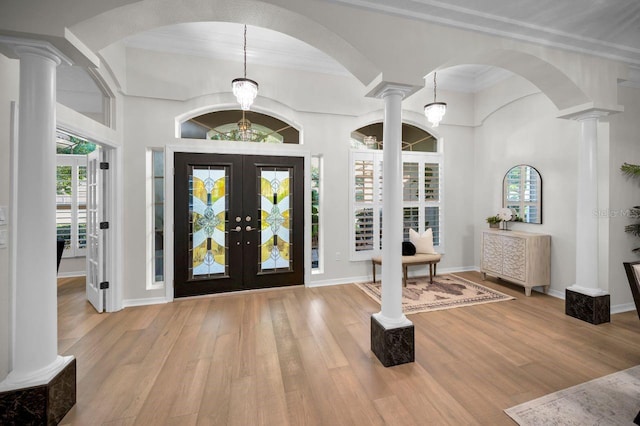 4962 Turtle Creek Trl, Oldsmar, FL 34677 - foyer with ornate columns, wood finished floors, french doors, arched walkways, and ornamental molding