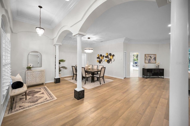 4962 Turtle Creek Trl, Oldsmar, FL 34677 - dining space with decorative columns, wood finished floors, ornamental molding, arched walkways, and baseboards