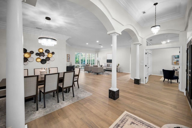 4962 Turtle Creek Trl, Oldsmar, FL 34677 - dining room with arched walkways, decorative columns, crown molding, wood finished floors, and recessed lighting