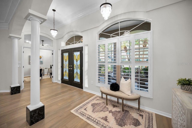 4962 Turtle Creek Trl, Oldsmar, FL 34677 - foyer entrance with decorative columns, french doors, wood finished floors, ornamental molding, and baseboards