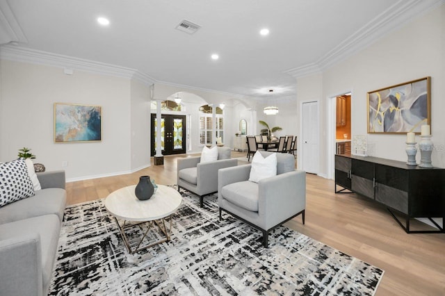 4962 Turtle Creek Trl, Oldsmar, FL 34677 - living area with arched walkways, ornate columns, crown molding, light wood-style flooring, and recessed lighting