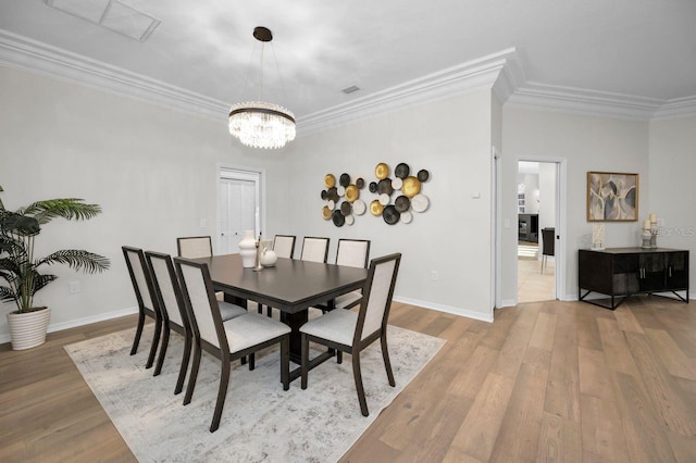 4962 Turtle Creek Trl, Oldsmar, FL 34677 - dining area featuring crown molding, a chandelier, wood finished floors, and baseboards