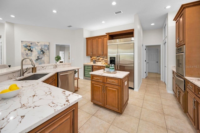 4962 Turtle Creek Trl, Oldsmar, FL 34677 - kitchen featuring appliances with stainless steel finishes, wine cooler, a warming drawer, a kitchen island, and a sink