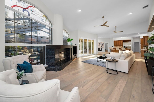 4962 Turtle Creek Trl, Oldsmar, FL 34677 - living room with ceiling fan, recessed lighting, light wood-style flooring, and a high end fireplace