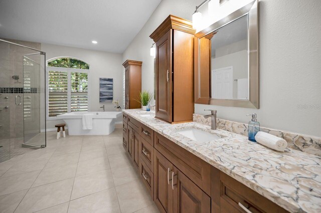 4962 Turtle Creek Trl, Oldsmar, FL 34677 - bathroom featuring double vanity, a stall shower, a soaking tub, and tile patterned flooring