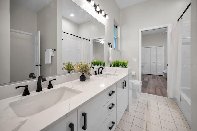 4962 Turtle Creek Trl, Oldsmar, FL 34677 - bathroom with double vanity, toilet, shower / bath combo with shower curtain, tile patterned floors, and recessed lighting