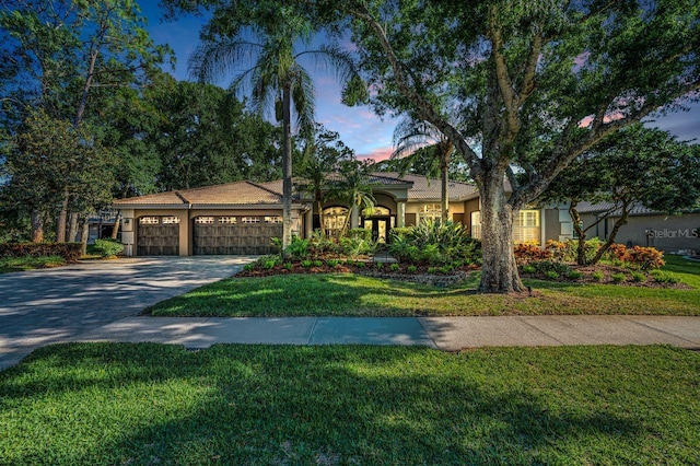 4962 Turtle Creek Trl, Oldsmar, FL 34677 - mediterranean / spanish-style house featuring stucco siding, concrete driveway, a garage, and a front yard