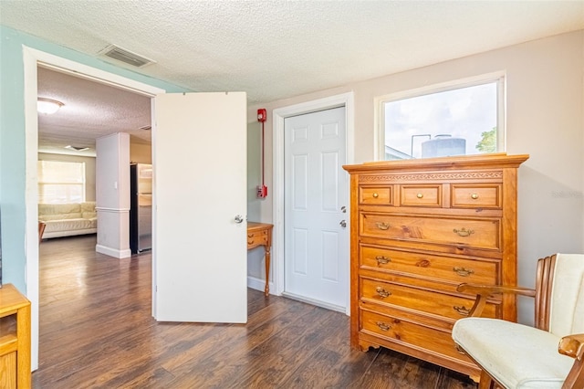 9020 Gray Fox Ln, Port Richey, FL 34668 - sitting room with dark wood-style floors and a textured ceiling