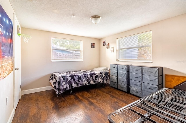 9020 Gray Fox Ln, Port Richey, FL 34668 - bedroom featuring wood finished floors, baseboards, and a textured ceiling