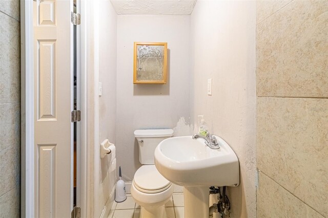 9020 Gray Fox Ln, Port Richey, FL 34668 - half bath featuring toilet and tile patterned floors
